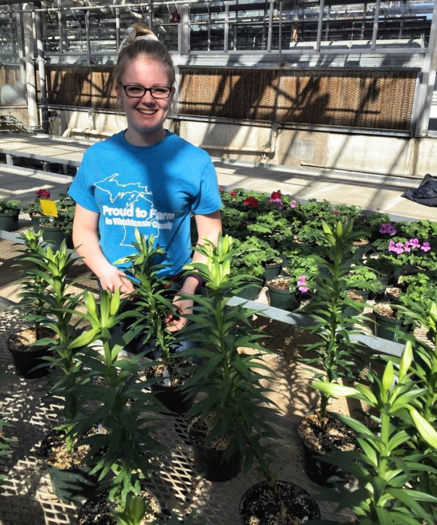 Happy last day of Ag Week from Katlin Blaine of Manchester. This photo was taken in the Greenhouse at MSU. Katlin studies Agronomy/Crop & Soil Sciences. She is a member of the MSU Collegiate Farm Bureau and is also active in the county Farm Bureau Young Farmer events and activities. She recently attended the Michigan Farm Bureau Growing Together Conference in Kalamazoo.
