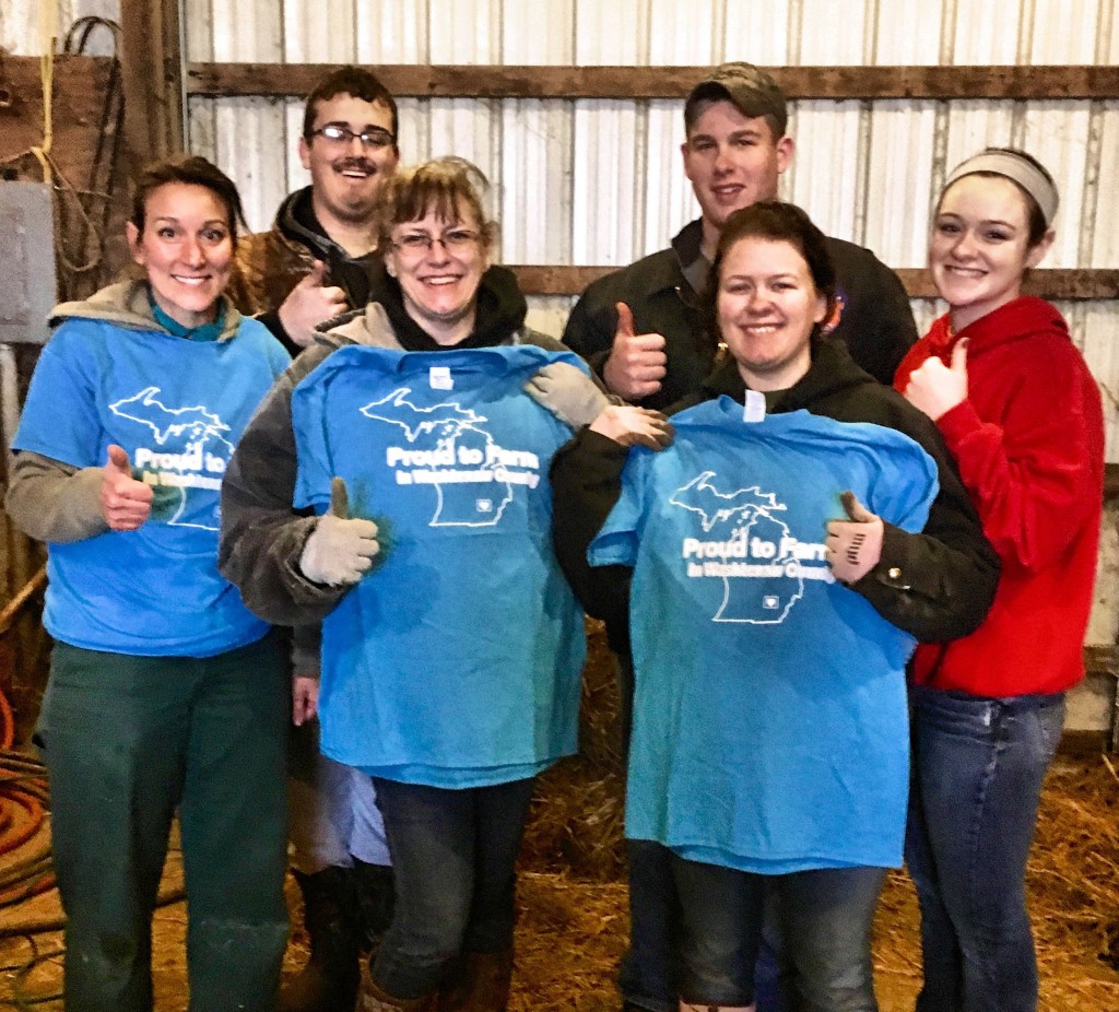 In late December we met up with Dr. Chelsea Render at the Wacker Farm and surprised Jacy, Cody and their mom Lauren Wacker with our blue t-shirts. Dr. Render was there to do ultrasounds on all their ewes. The ultrasound can show if the ewe is pregnant, and gives some idea about the health and gestation stage of the unborn lambs. You can see Jacy in some photos taking notes as Dr. Render was examining the sheep. Chasing ewes and isolating them for the exam took muscle, speed and extra hands! Thanks to the barn helpers Josh Sannes, Natalie Johnson, and Brandon Puckett. The group (minus Cody) posed for a “thumbs up” photo: All the ewes were pregnant and healthy! UPDATE: Jacy’s flock had 27 lambs.