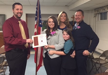 Manchester High School principal Kevin Mowrer presents Rachel Beagle her Student of the Month Award, shown her with he mother Deb, father Jim and sister Jordan. Photo courtesy of Manchester High School.