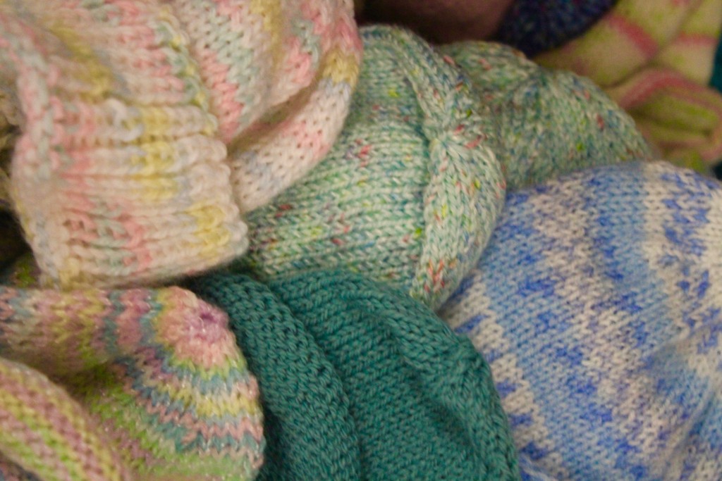 Premie hats knitted by the Chain Gang waiting in Pyramid Office Supply and Emporium to go to U of M Mott's NICU.