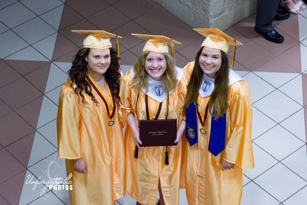 Excited graduates Caroline Wozniak, Megan Seames, and Erin Glavin share a happy moment following the commencement exercises.