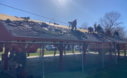 Volunteers come together for Alumni Field pavilion roofing project