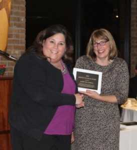 Karin Villarreal, left, accepts the Commitment to Community Award