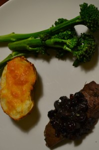 Deer steak with blueberry reduction. Served with a twice baked cheese potato and steamed broccolini.
