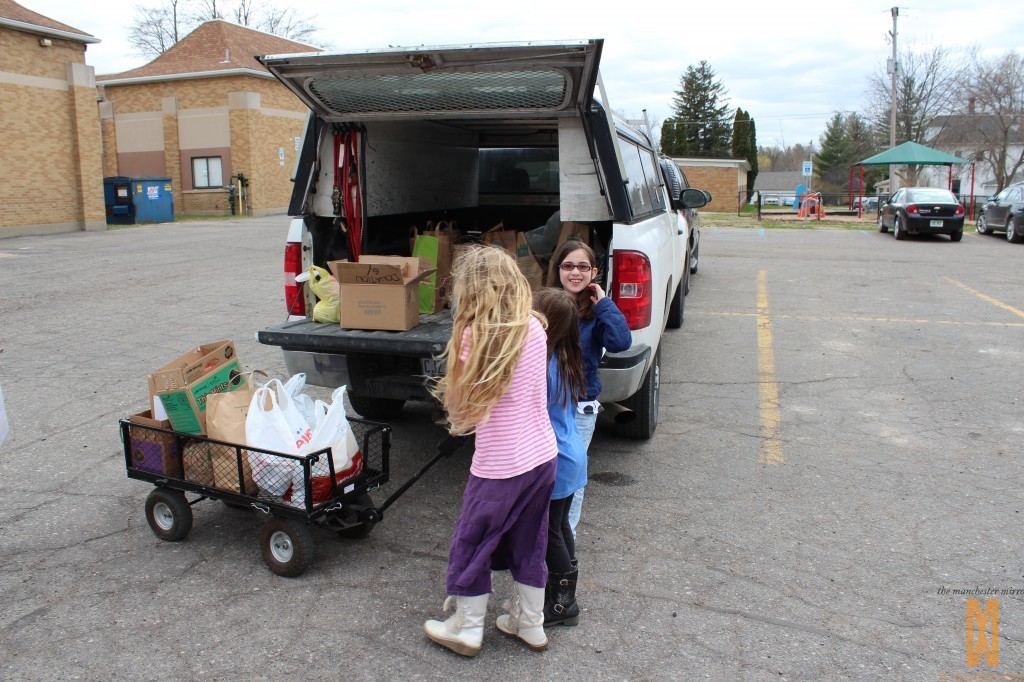 Unloading all of the goodies to take into the food bank.  (L to R) Miranda Austin, Abbi Austin, and Emma Paxton