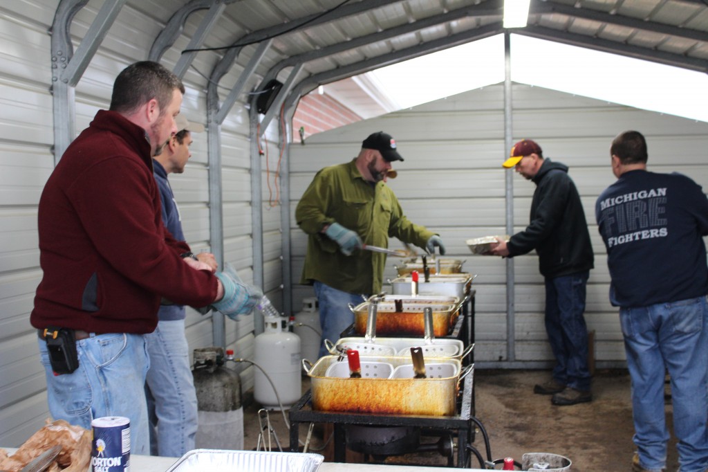 Most guests don't realize that the fish is actually fried outside of the church, in what appears to be a carport.  Four frying stations are needed to handle all of the fish and french fries for the sizable crowd that gathers. 