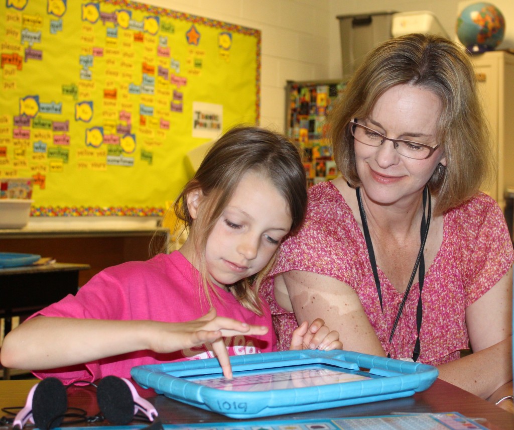 Meghan Somerville works on her IPad while Mrs. Fielder keeps an eye on her learning. 