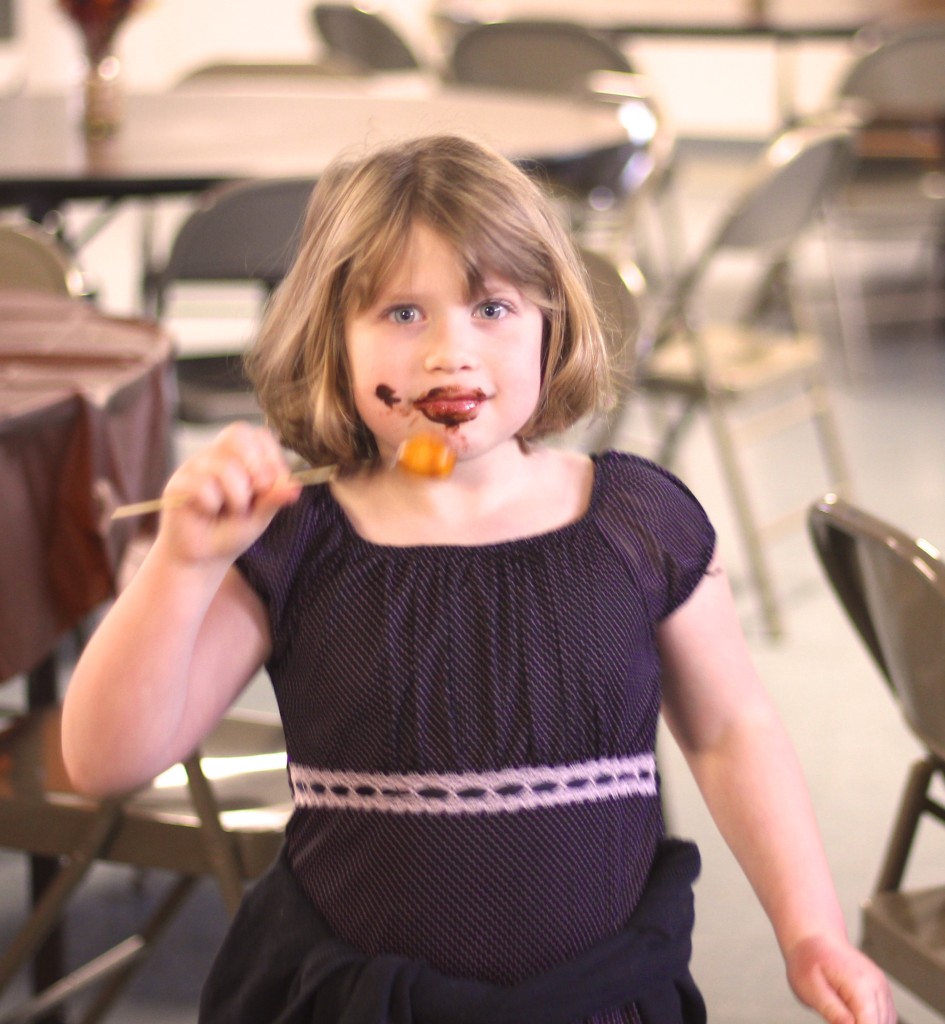 Maddie Marsh eats the chocolate off a chocolate covered kumquat.