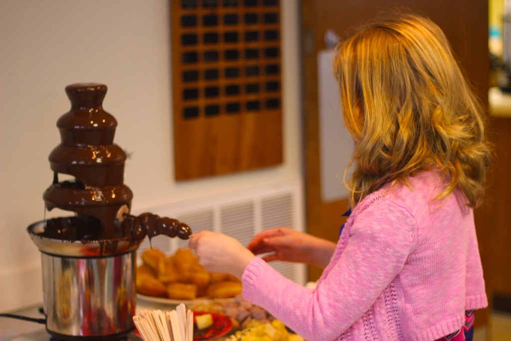 Claire Marsh dunks fruit, marshmallows and chocolate meringue cookies in the chocolate fountain.  
