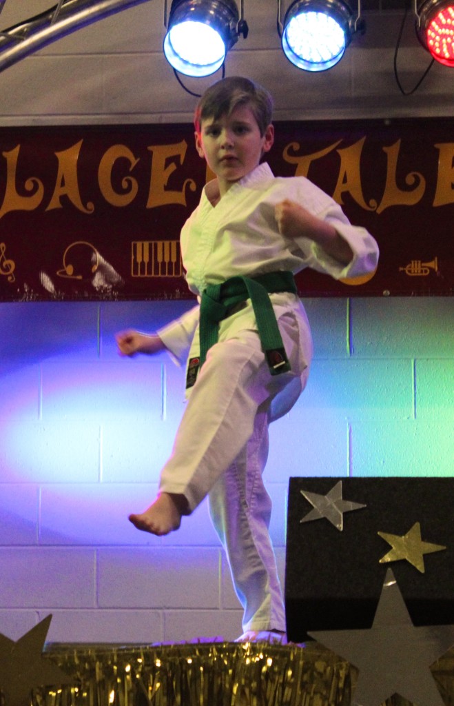 1st grader, Joshua Gregory demonstrated karate moves and finished by breaking a piece of wood with a kick.