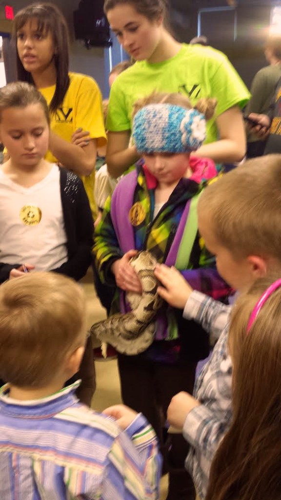 Elementary students pet a python at Math and Science night Friday in Klager's cafeteria. 